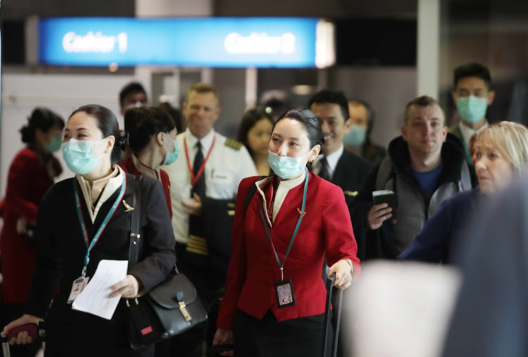 Passengers arriving on a flight from Asia to Cape Town.