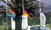 South African and German flag at half mast at the entrance of Rheinmetall Denel Munition plant in Macassar where several employees were killed after an explosion on site yesterday.