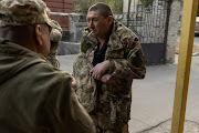 An injured Ukrainian soldier smokes outside an emergency room, amid Russia's invasion in Ukraine, at a hospital in Bakhmut, Donetsk region, Ukraine. 