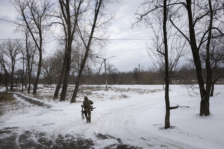 A Ukrainian soldier walks through the snow on February 12, 2023 in Chasiv Yar, Ukraine, near the frontline between Ukrainian and Russian troops.