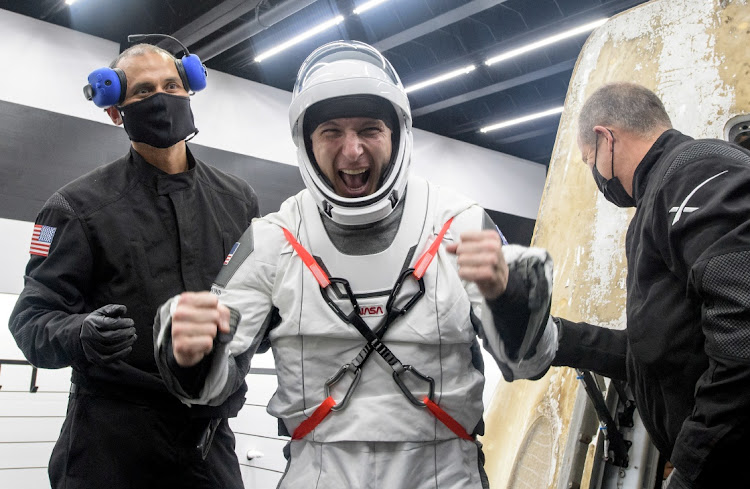 Nasa astronaut Mike Hopkins is helped out of the SpaceX Crew Dragon Resilience spacecraft recovery ship after he, Nasa astronauts Shannon Walker, Victor Glover and Japan Aerospace Exploration Agency (JAXA) astronaut Soichi Noguchi landed in the Gulf of Mexico off the coast of Panama City, Florida, US, on May 2 2021.