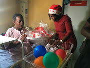 Health MEC in Mpumalanga showering new babies born on Christmas Day with gifts. 