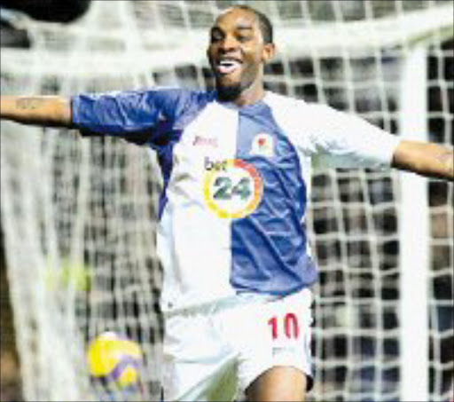 PREDATOR: Blackburn Rovers' Benedict McCarthy celebrates after scoring the side's third goal against Wigan Athletic on Monday. Pic. Nick Potts. © AP.