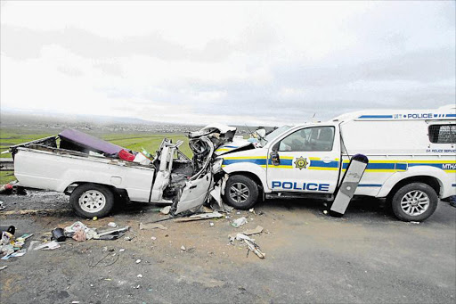 HORROR SCENE: The aftermath of the head-on collision between a police van and a bakkie carrying passengers on the R61 between Mthatha and Mthatha Airport near Dosi village yesterday. The accident claimed the lives of three of the bakkie’s passengers Picture: LULAMILE FENI