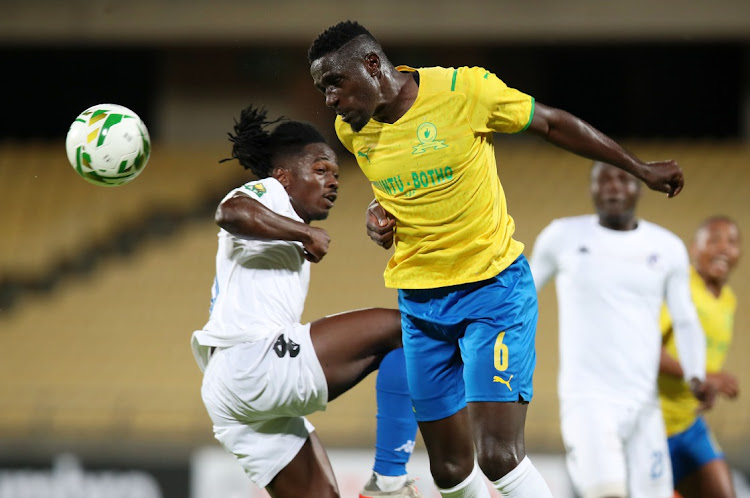 Brian Onyango of Mamelodi Sundowns clears ball from Mohamed Abdelrahman Yousif of Al Hilal during the CAF Champions League 21/22 match between Mamelodi Sundowns and Al Hilal.