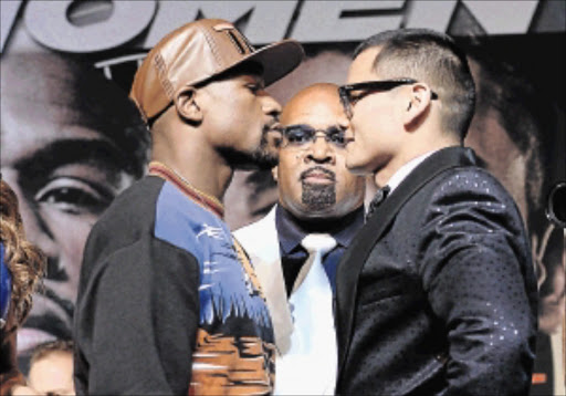 FACE OFF: WBC welterweight champion Floyd Mayweather jnr, left, and Marcos Maidana will meet in a rematch on Saturday in Las Vegas Photo: Bryan Steffy/WireImage