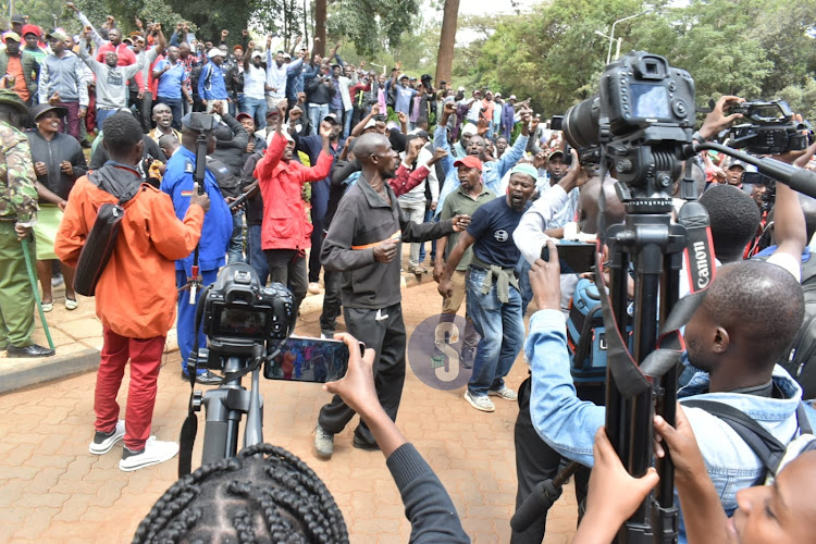 Former Mungiki leader Maina Njenga's supporters chanting outside DCI headquarters on May 25, 2023.