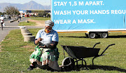 Aida Gxowa in front of an awareness board in Khayelitsha. Residents now have to guard against a  resurgence of infections.
 