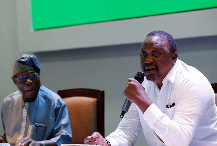 Former Kenya's President Uhuru Kenyatta, who is flanked by former Nigerian President Olusegun Obasanjo, attends the signing of the implementation of the cessation of hostilities agreement between the Ethiopian government and Tigrayan forces, laying out the roadmap for implementation of a peace deal, in Nairobi, Kenya November 12, 2022.