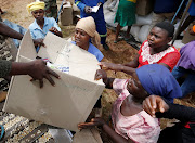 Victims of Cyclone Idai receive food aid at Siverstream Estates in Chipinge, Zimbabwe in the wake of Cyclone Idai's rampage. 