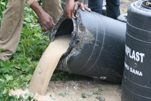 Administration police officers pour illicit brew