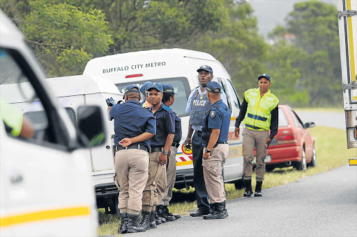 MONITORING THE SITUATION: Police keep a close eye as land grab continues along the R72 Picture: MICHAEL PINYANA