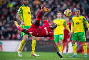 Sadio Mane of Liverpool scores their first goal as Grant Hanley, Max Aarons and Joshua Sargent of Norwich City look on in the Premier League match at Anfield  in Liverpool on February 19 2022.