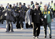 Members of the Brazilian national soccer team walk on the tarmac after arriving at Johannesburg's O.R. Tambo airport May 27, 2010. The 2010 FIFA World Cup kicks off on June 11.      REUTERS/Mike Hutchings     (SOUTH AFRICA - Tags: SPORT SOCCER WORLD CUP)