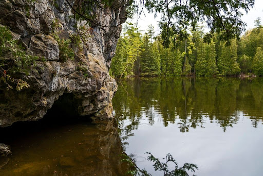 A small cave at the side of a lake in Rockwood Conservation Area near Guelph, Ontario