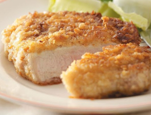 a breaded pork chop on a plate