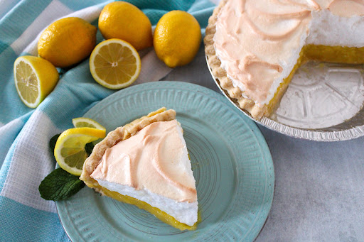 A slice of No-Fail Lemon Meringue Pie on a plate.