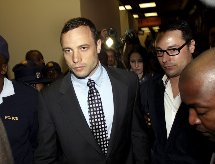 Oscar Pistorius in the Pretoria magistrate's court on June 4 2013 with his brother Carl. Oscar was jailed for killing his girlfriend Reeva Steenkamp. File photo.