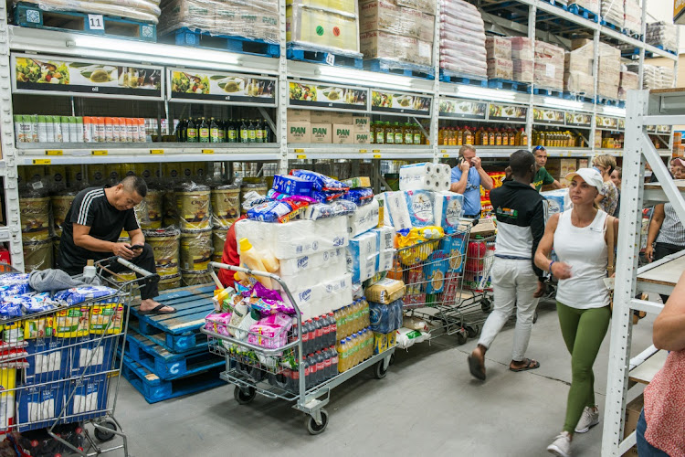 Shoppers wait in long queues inside a Makro store in Pretoria in this March 16 2020 file photo. Picture: BLOOMBERG via GETTY IMAGES/WALDO SWIEGERS