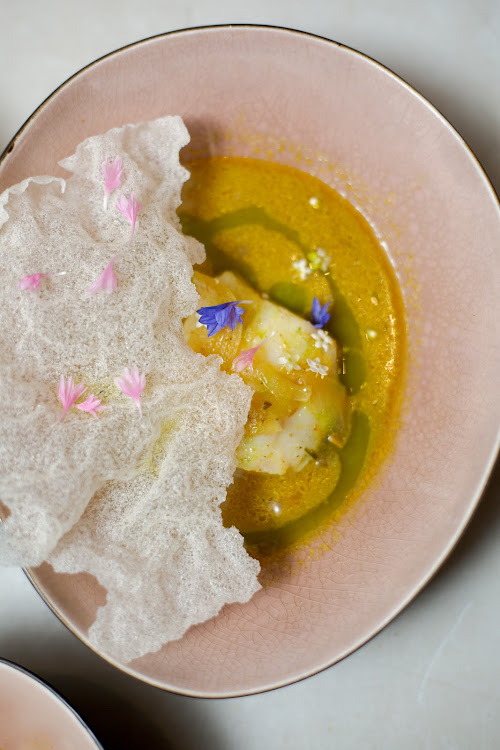 Pickled fish in broth, coriander oil and puffed fish skin.