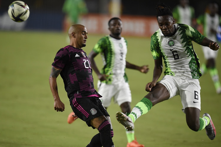 Nigeria defender Olisa Ndah (6) kicks a pass intended for Mexico defender Luis Rodriguez (21) away during the second half at the Los Angeles Memorial Coliseum.