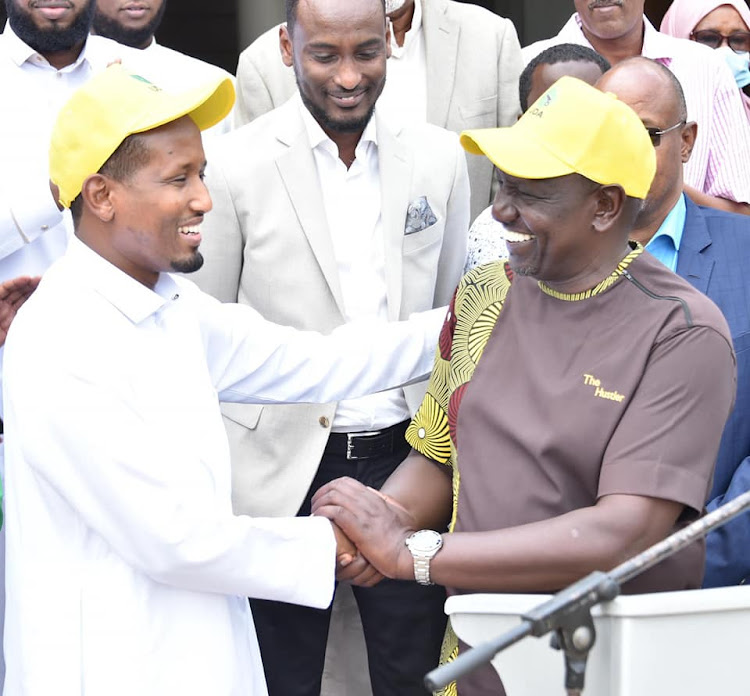 Deputy President William Ruto shares a light moment with Wajir Deputy Governor Ahmed Muktar when he took his camping to Wajir on Thursday, March 31.