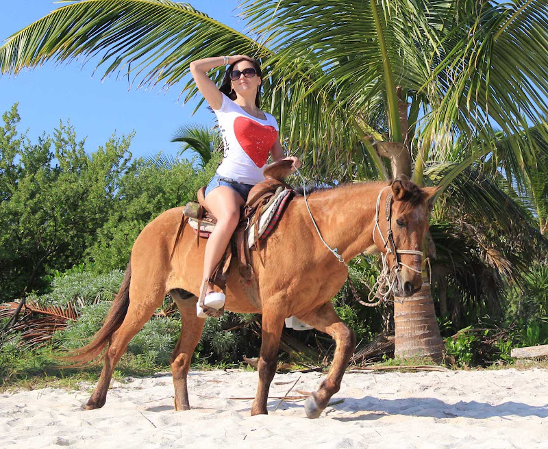 Horseback riding on a beach in the Riviera Maya of Mexico.