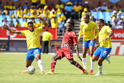 Victor Letsoalo of Sekhukhune United is challenge by Sipho Mbhule, Thapelo Morena and Andile Jali of Mamelodi Sundowns during the DStv Premiership match at Loftus Versfeld Stadium on January 28, 2023.