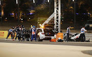 Track marshals clear the debris following Romain Grosjean's crash during the F1 Grand Prix of Bahrain at Bahrain International Circuit on November 29 2020.