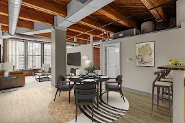 Modern apartment interior with exposed beams, open-plan living area, dining set, and city view.