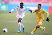 Bafana Bafana's Sphelele Mkhulise challenges Woula Macire Sane of Senegal for the ball during the match. 