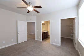 Bedroom facing an ensuite bathroom and walk-in closet 