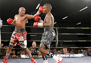 Simpiwe Vetyeka, left,  throws a punch at  Lerato Dlamini during  the semifinal  of the Golden Gloves Super 4.