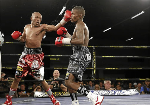 Simpiwe Vetyeka, left, throws a punch at Lerato Dlamini during the semifinal of the Golden Gloves Super 4.