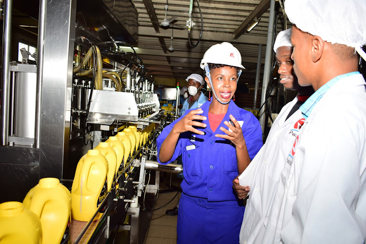 Pwani Oil staff at the Jomvu plant explains to journalists the process of making edible oil. Photo/CHARLES MGHENYI