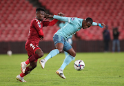 Thabang Monare of Orlando Pirates is challenged by Kamohelo Sithole of Sekhukhune United in the DStv Premiership match at Ellis Park in Johannesburg on April 6 2022.