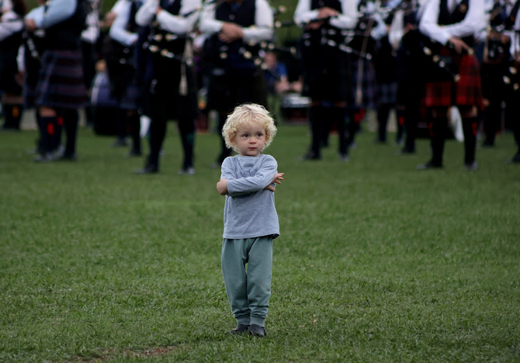 A child joins the the mass bands performance at the Highland Gathering in Hutchison Park Sport Grounds