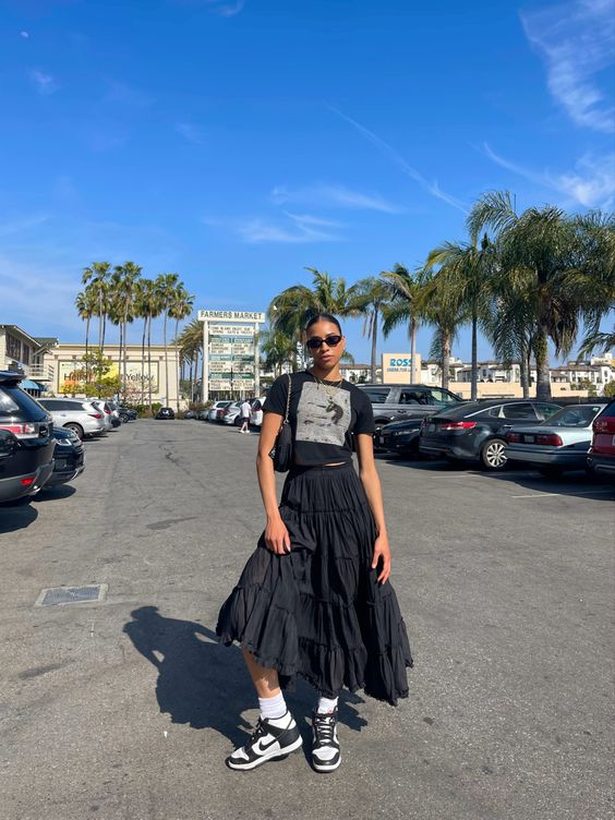 lady rocks maxi skirt and crop top with her sneakers