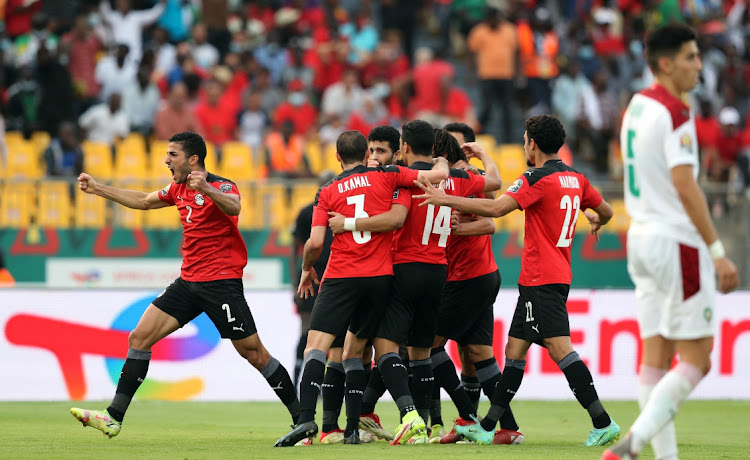 Mohamed Salah celebrates with teammates after scoring the opening goal.