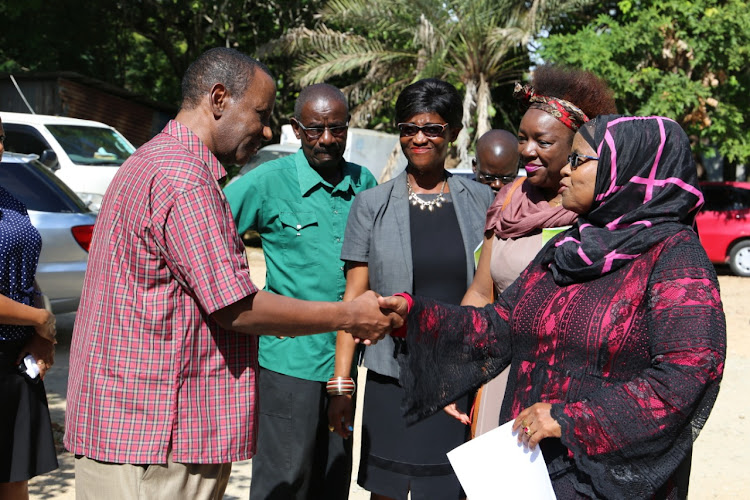 Coast Development Authority chair Mohammed Keinan greets Agricultural Society of Kenya Mombasa chair Anisa Abdalla at CDA offices in Mombasa on Tuesday