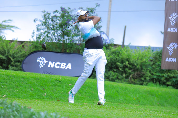 Roy Nichola follows the path of his tee during the NCBA golf series at Limuru Country golf club.