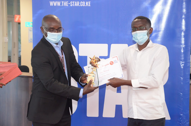 General News Editor Francis Mureithi awards John Muchangi who won general news reporter of the year