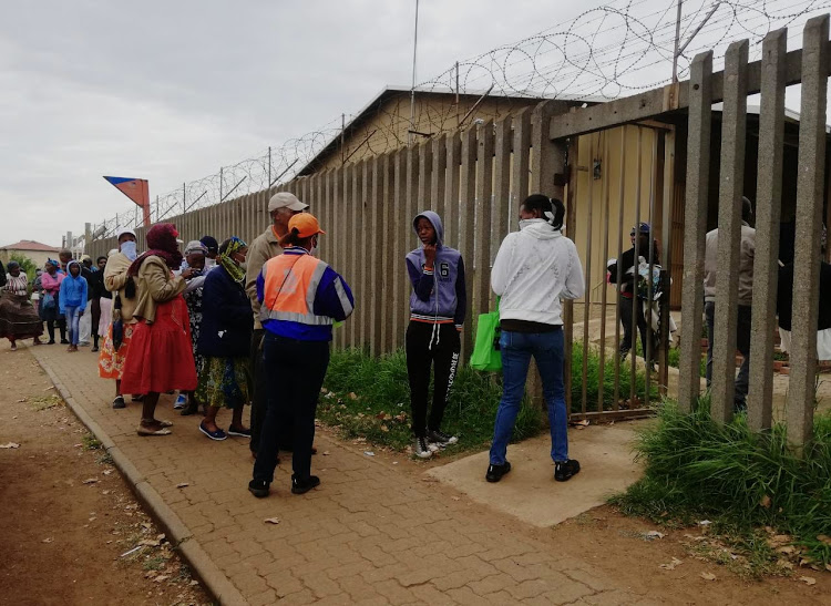 Sassa grant beneficiaries queue in Pimville, Soweto.