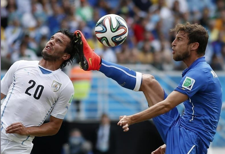 Italy's Claudio Marchisio in action with Uruguay's Alvaro Gonzalez during the 2014 World Cup