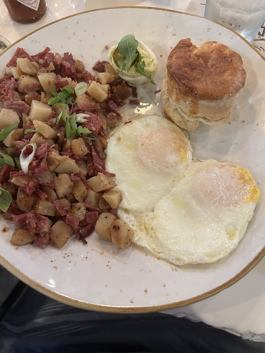 Homemade hash and potatoes eggs over medium gfree biscuit