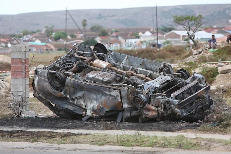 The charred wreck of the taxi in which Denver Kock died after it caught fire in William Slammert Drive, Bethelsdorp, on Thursday morning