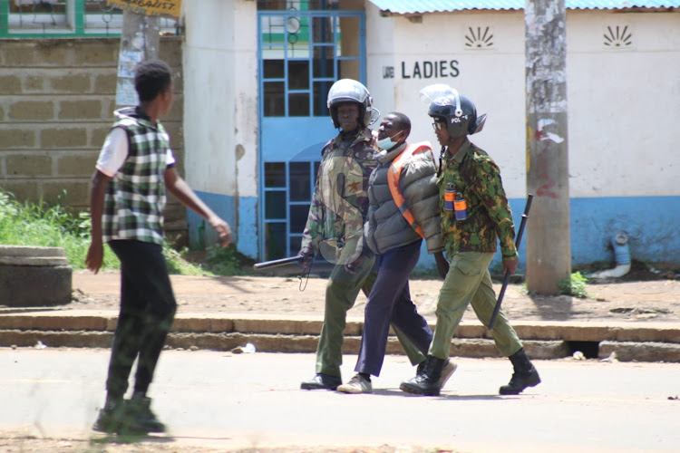 Police officers arrest a boda boda operator in Kisumu on May 2, 2023.