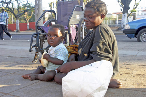 Mother with child begging. File photo.