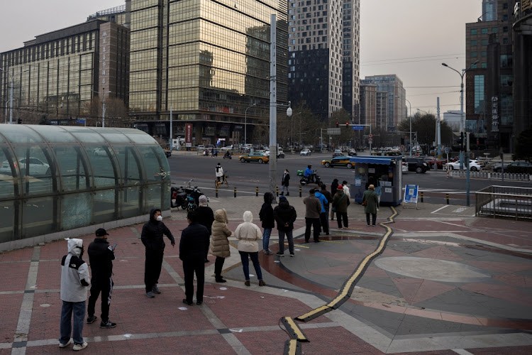 People wait in line to get their swab test as coronavirus disease (COVID-19) outbreaks continue in Beijing, December 9 2022. Picture: REUTERS/THOMAS PETER