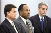 CHARGED: OJ Simpson, center, with his lawyers Gabriel Grace, right, and Yale Galanter during Simpson's arraignment in Las Vegas on Wednesday. Pic Ethan Millet. 28/11/2007. © AP